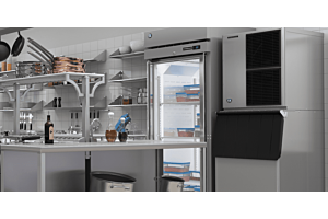 A commercial kitchen scene featuring a Hoshizaki Modular Crescent Cuber ice machine stacked on a matching bin next to a glass-door reach-in refrigerator