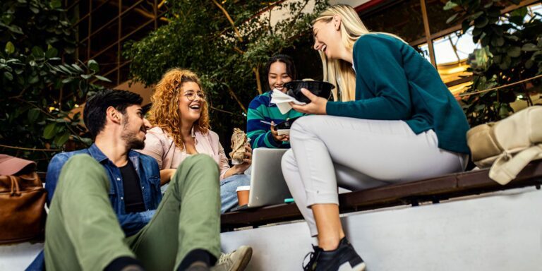 Hoshizaki equipment may have been used to prepare or store the food enjoyed by students sitting together during a campus lunch break