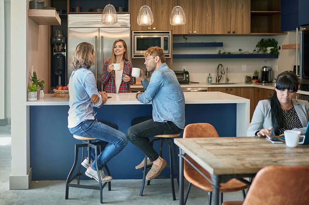 A Hoshizaki ice and water dispenser in a corporate office or commercial business breakroom